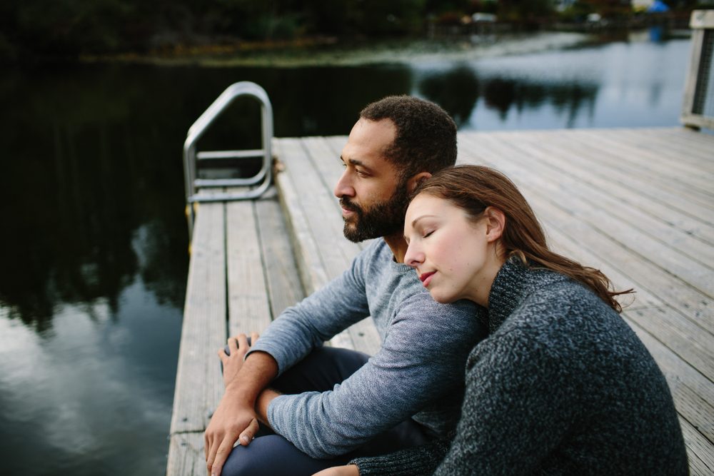 Man and woman sitting on a dock