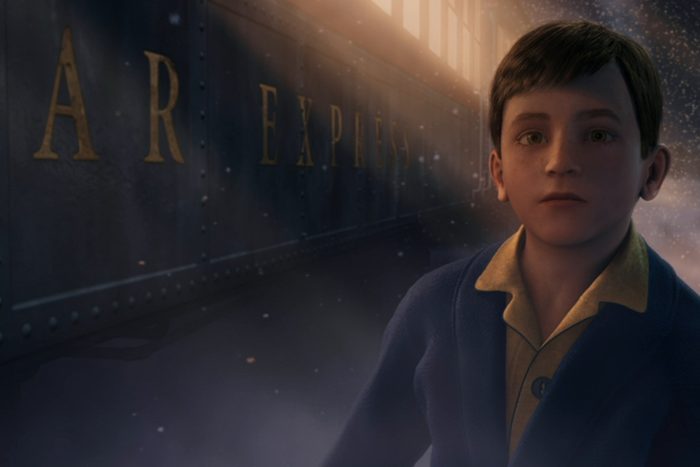 A young boy stands near a train, looking upwards, with 