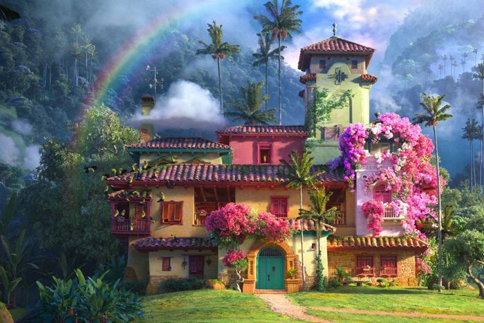 Colorful house adorned with flowers, situated beneath a rainbow. Surrounded by lush greenery and palm trees in a picturesque, misty mountainous setting.