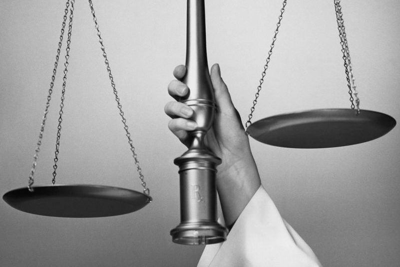 MAN HOLDING SCALE OF JUSTICE