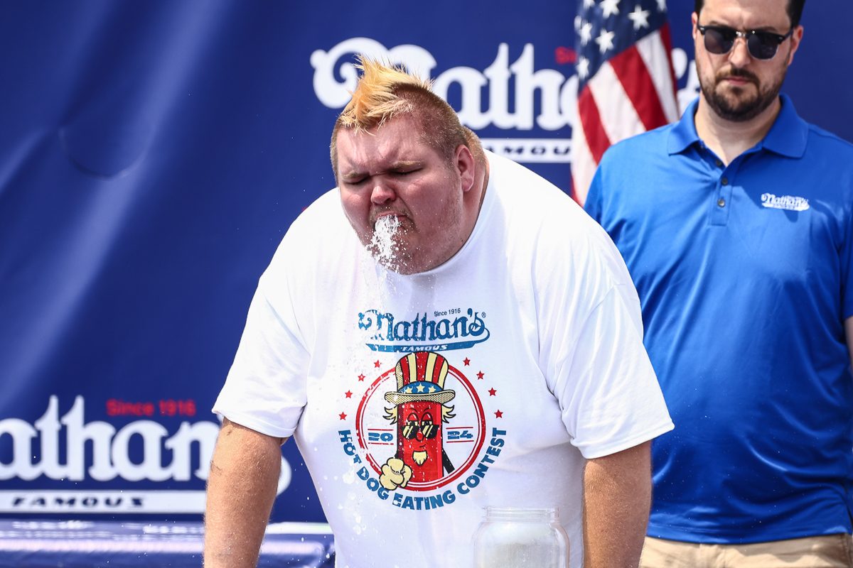 man puking at an eating contest