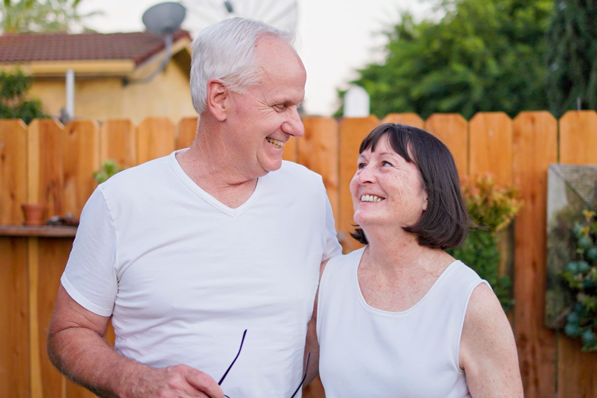 Senior married couple smiling towards each other